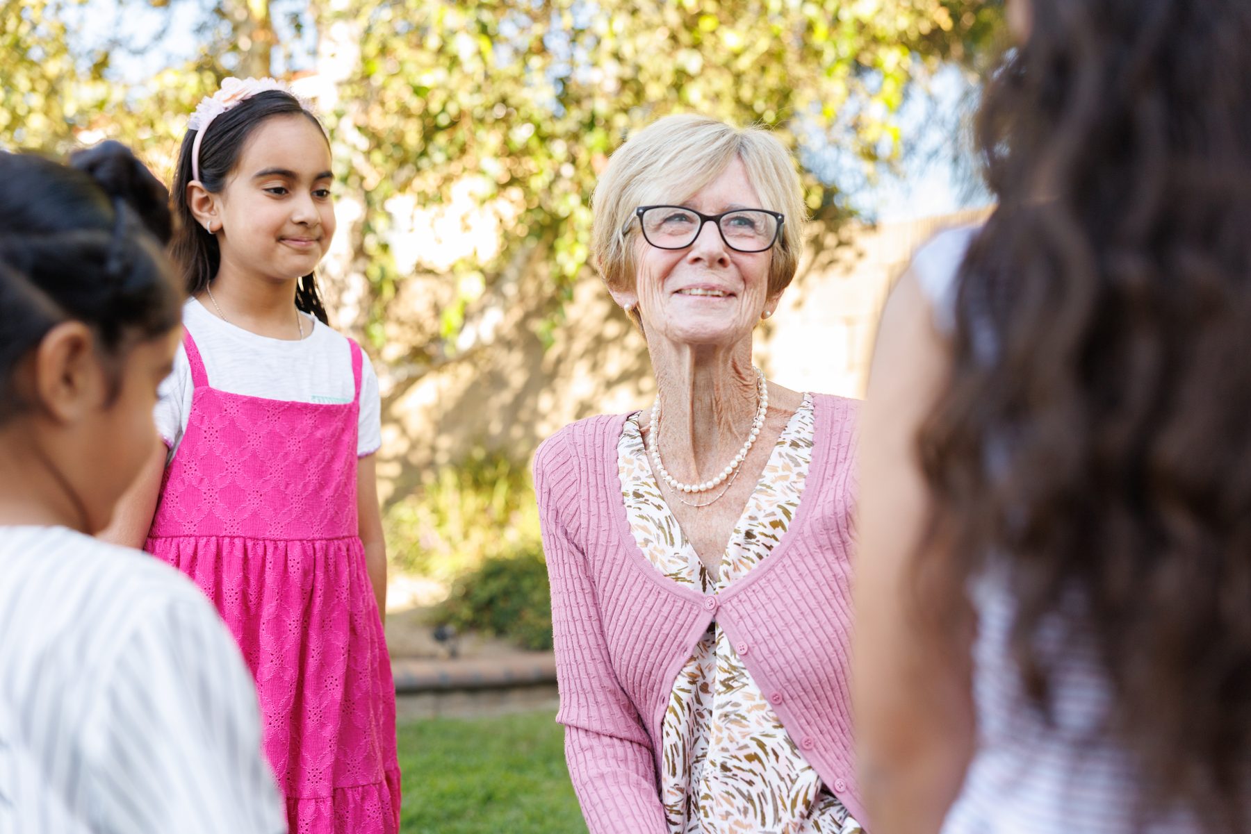 Jeanie McHatton talking with elementary students on a lawn