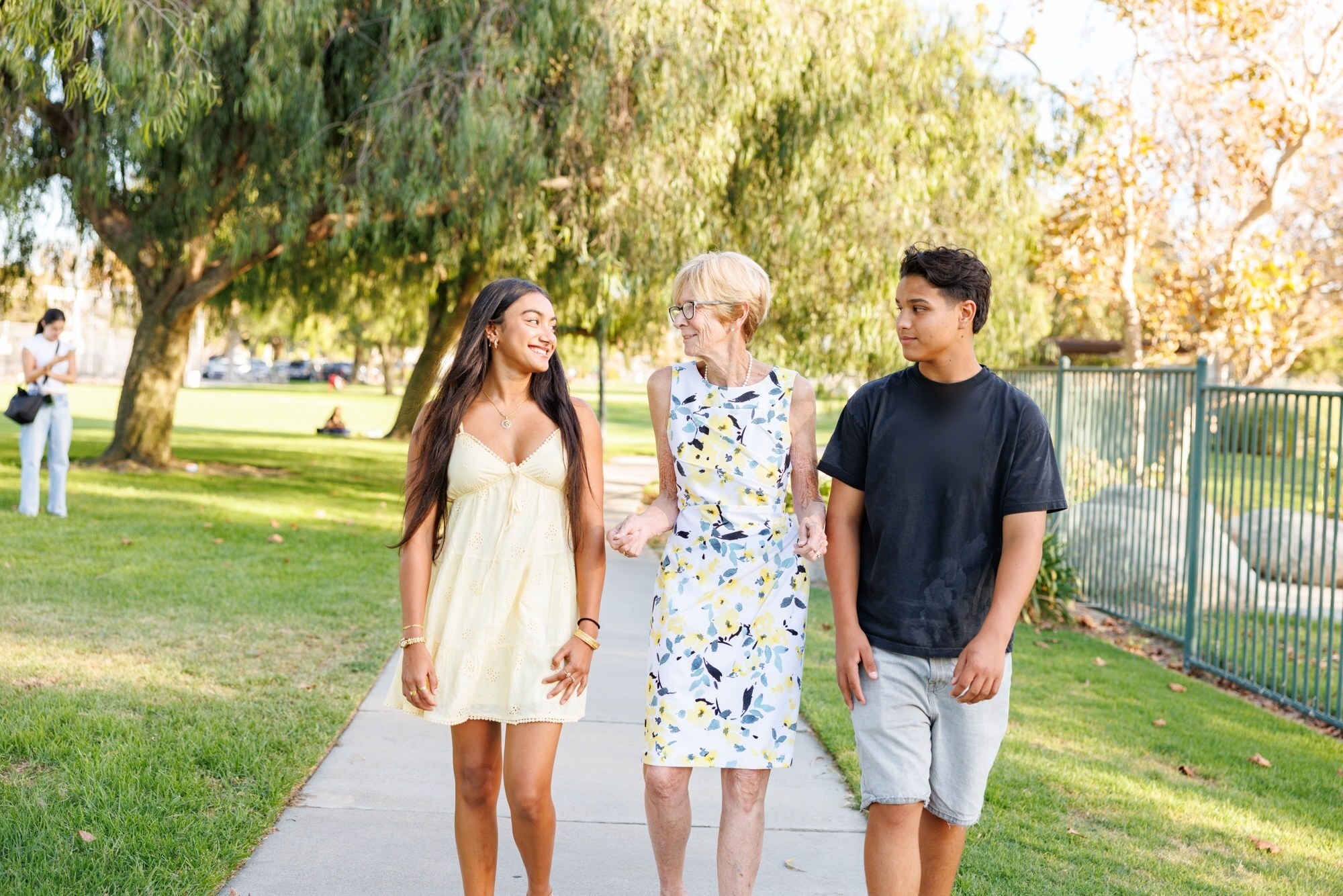 Jeanie McHatton walking through the park with two high school students
